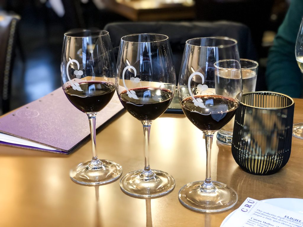 Three glasses of red wines that is part of a wine flight at Cru Food and Wine Bar