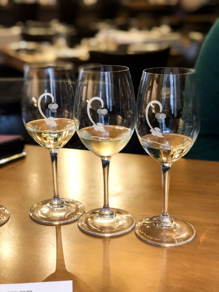 Three glasses of white wines that is part of a wine flight at Cru Food and Wine Bar