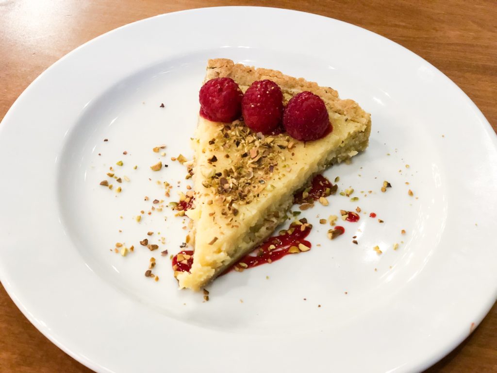 Lemon Tart with raspberry and pistachio crumbles