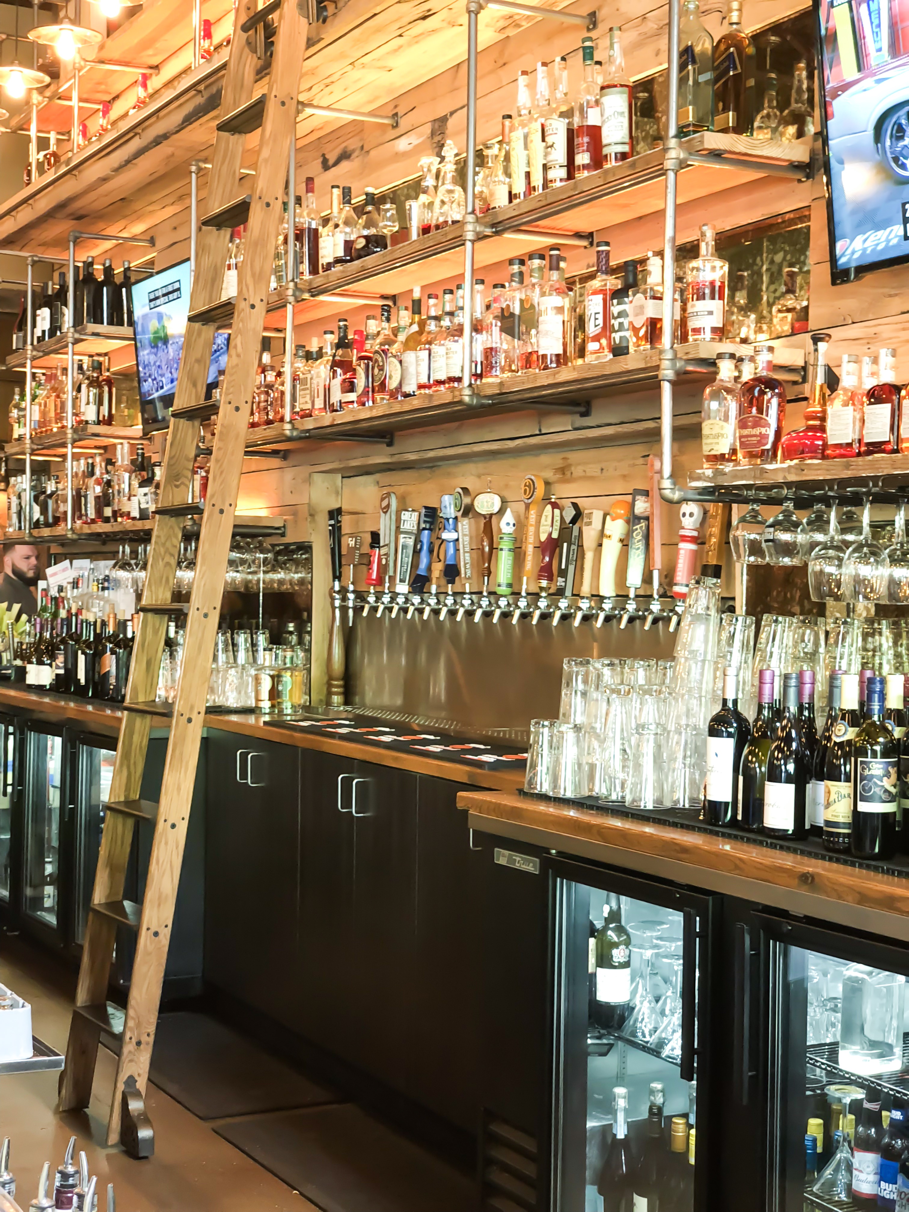ladder in front of a full bar at a restaurant