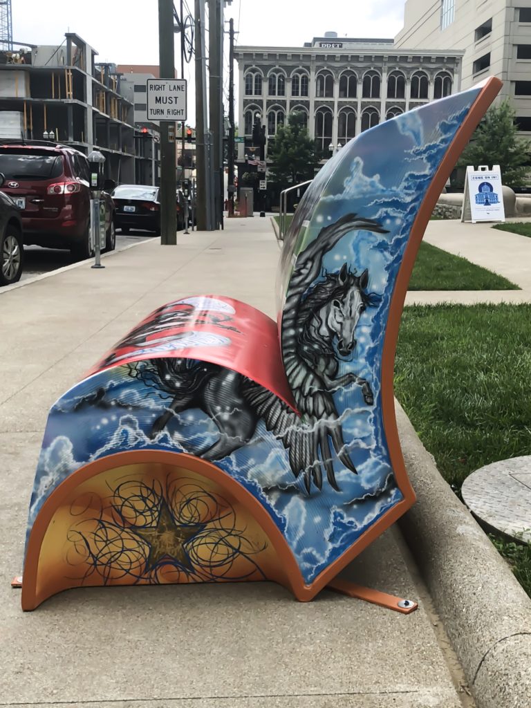 In the summer of 2018, Arts Connect, LexArts and The Carnegie Center for Literacy and Learning has made Lexington more colorful with their collaborative project, Book Benches.​ Book Benches are thirty five book-shaped functional benches that are placed throughout downtown Lexington to celebrate Kentucky's literary heritage, to encourage reading, and provide a place for rest. Each bench is illustrated and themed around different works by Kentucky authors and will remain on display for the duration of the summer. #sharethelex #art #painting #artist #author #book #lexingtonky #kentucky #visitlex #bench