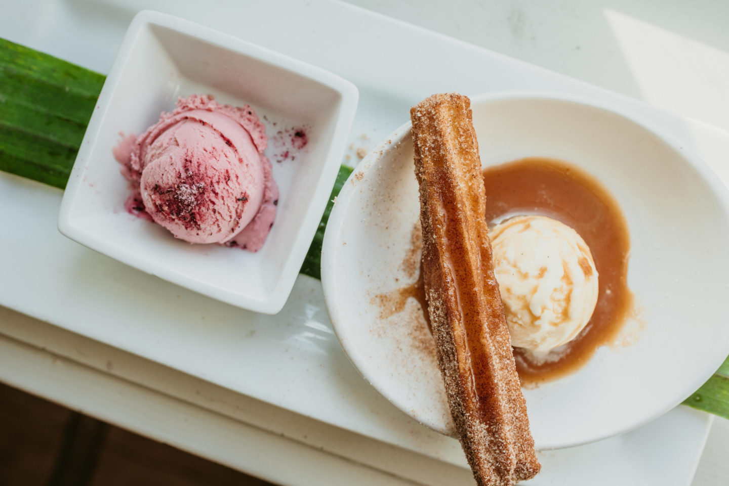 Churro Sundae with Strawberry Hibiscus Ice Cream on a square and circular plate