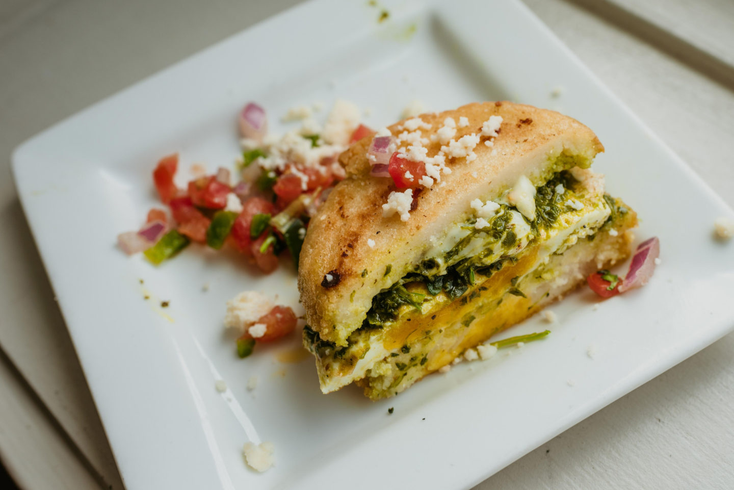 Arepas on a white square plate from Corto Lima in Lexington, Kentucky