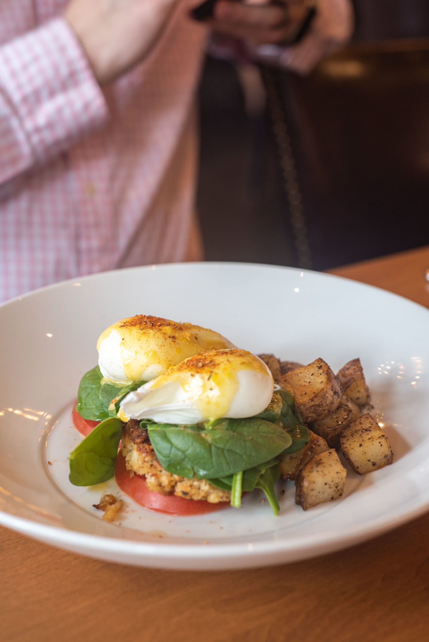 Cru Crab Cake Benedict. It came with baby spinach, organic eggs, fresh eggs, fresh herb hollandaise, and rosemary yukon potatoes.