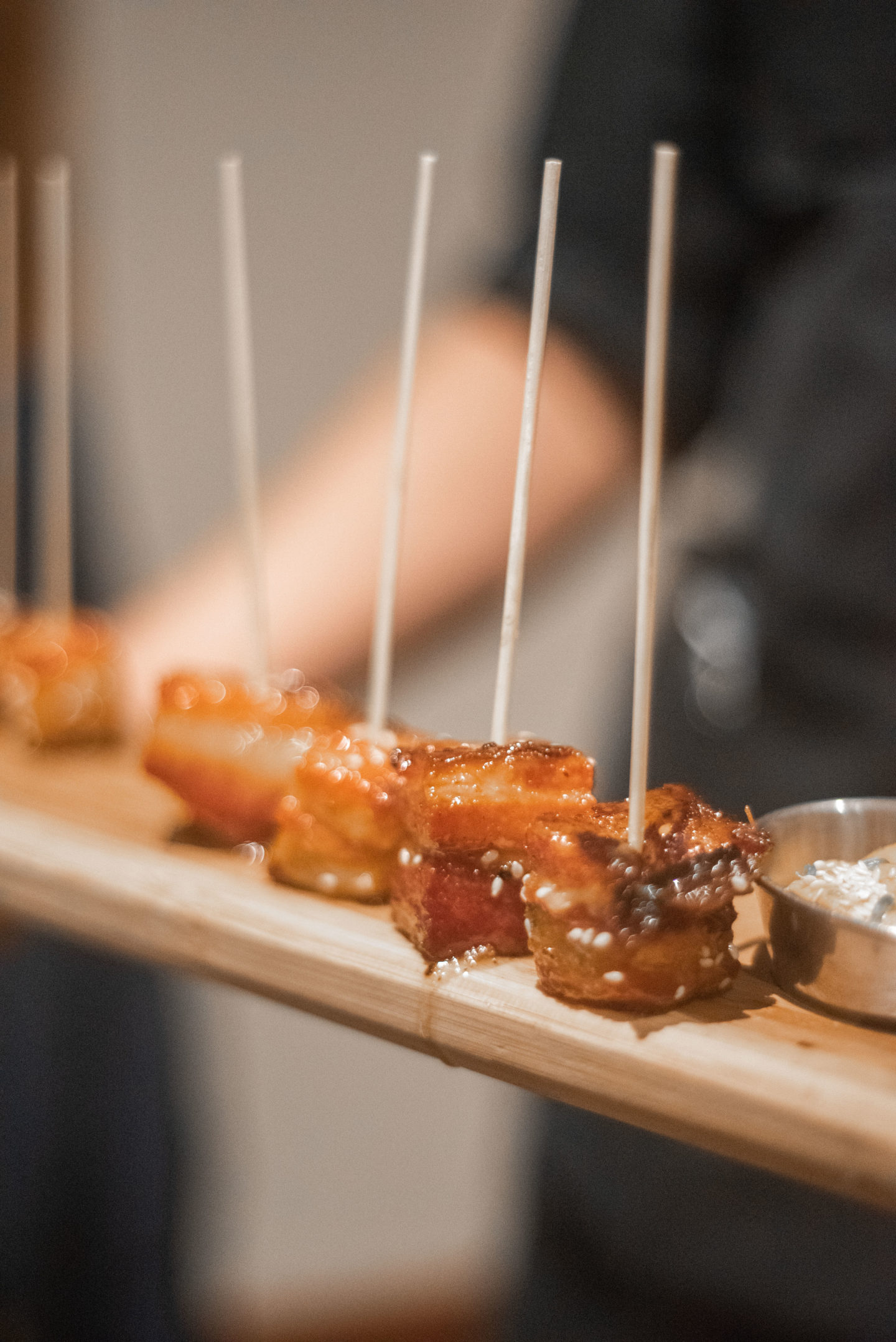 Pieces of pork belly on toothpicks