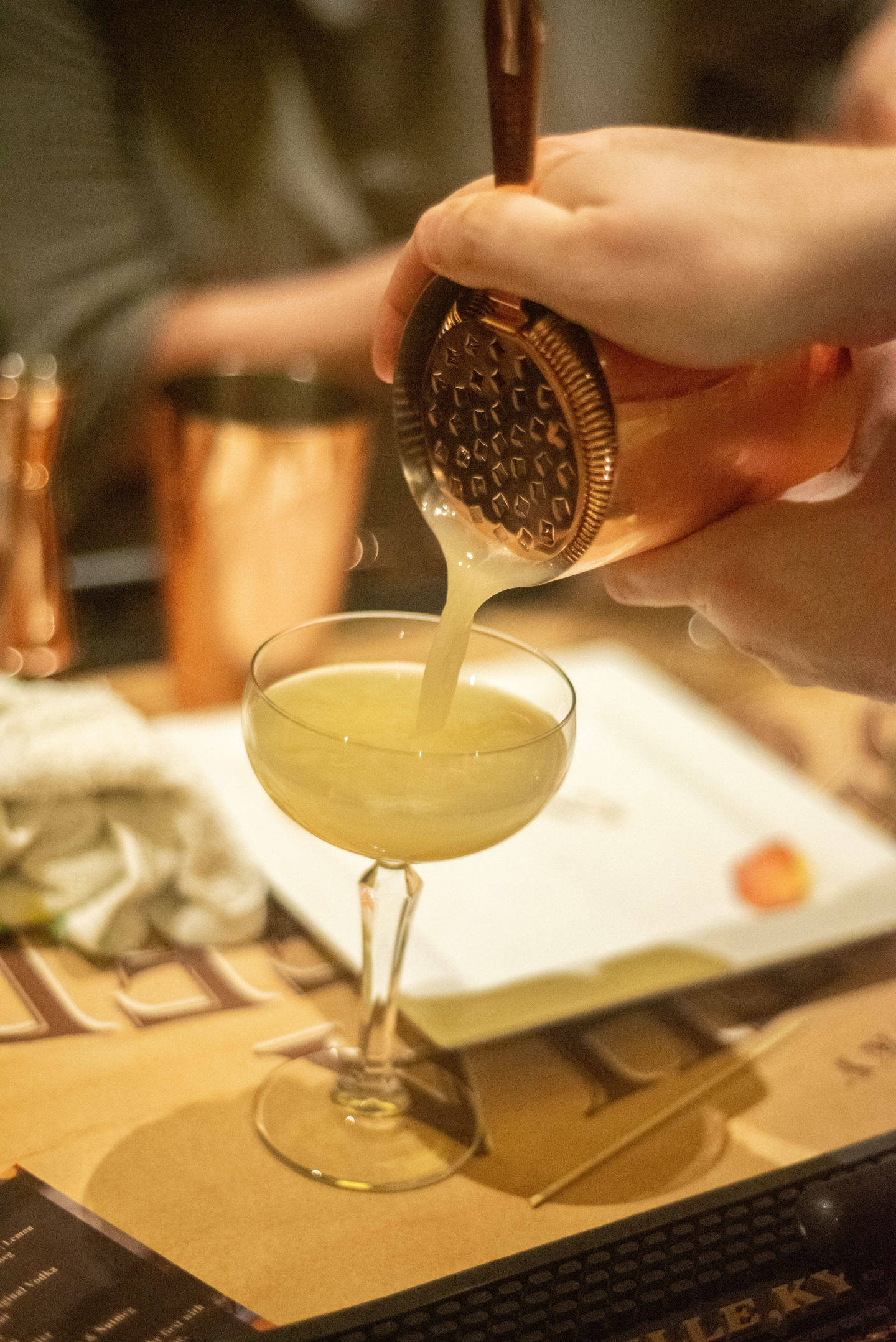 Drink being poured into a cocktail class