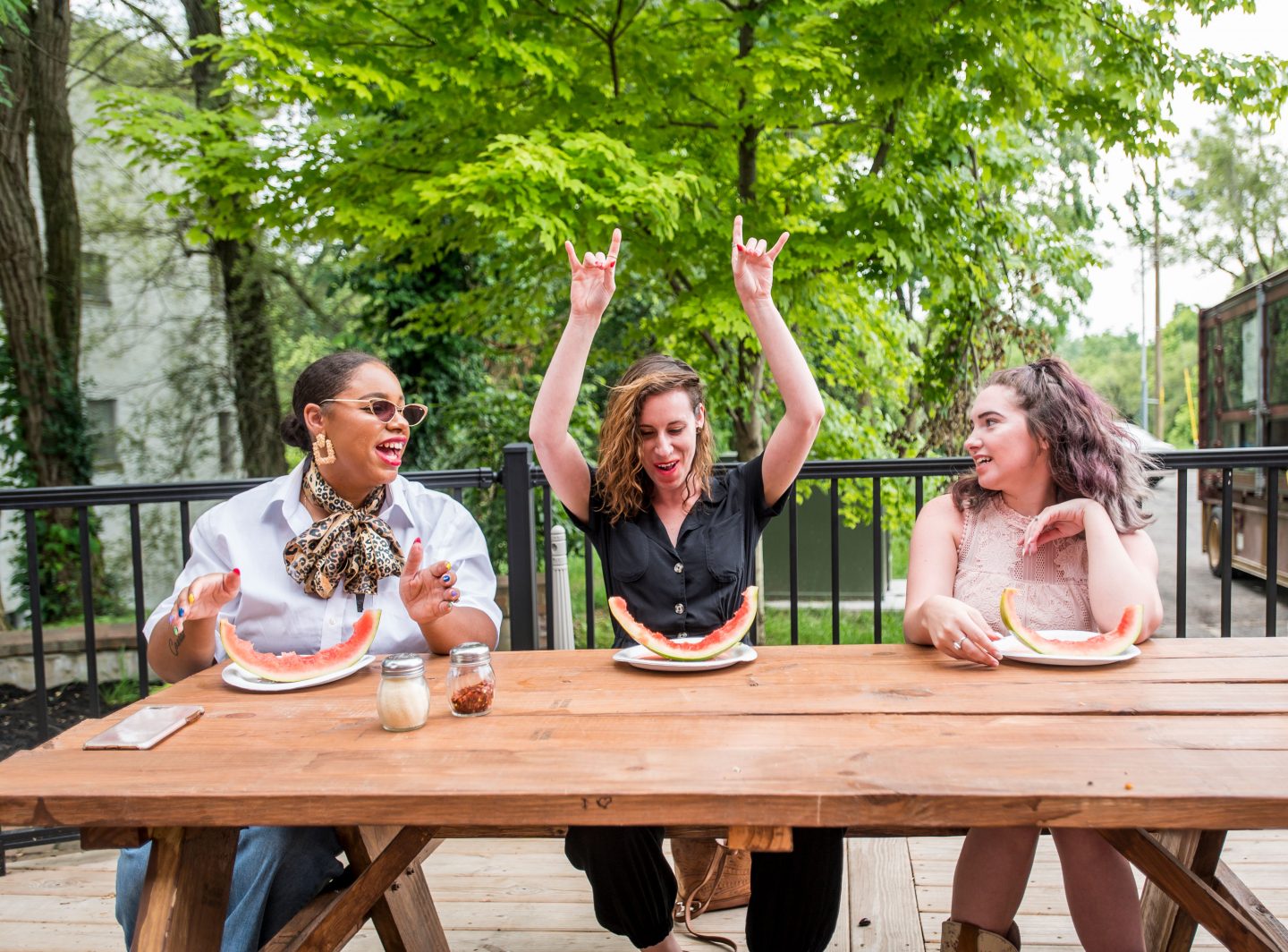 Three girls eating watermelon outside