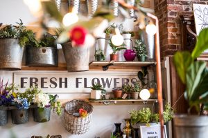 Flowers with a sign that says fresh flowers