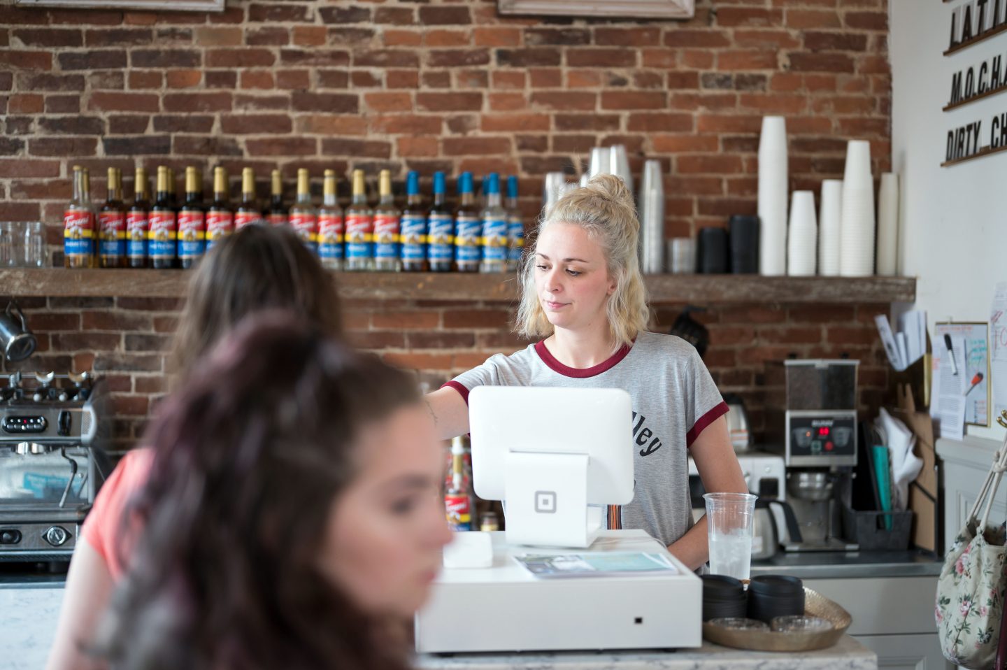 Barista serving drinks to a customer