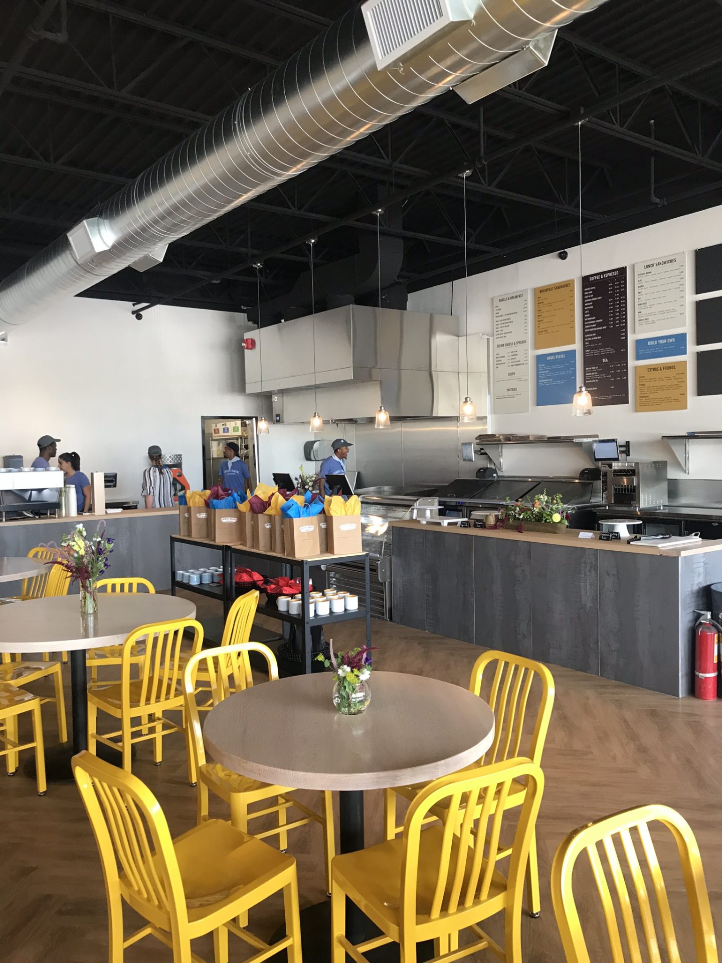 Yellow chairs and wooden tables inside of a restaurant