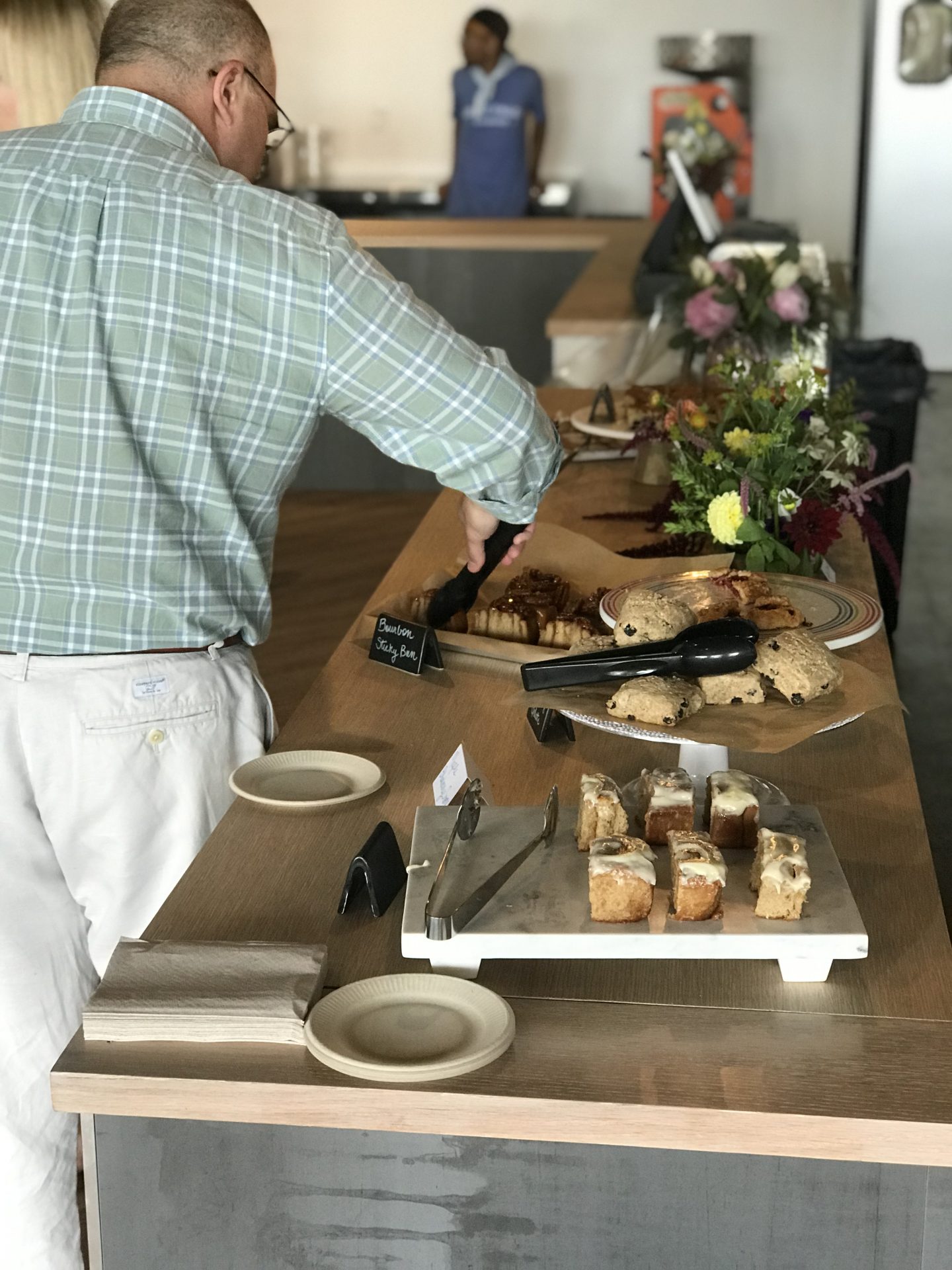 Man picking out a dessert from a dessert table