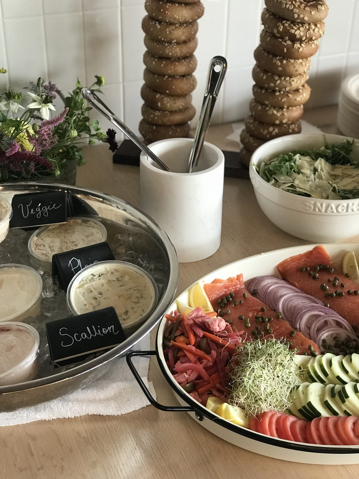 Dips and vegetables and bagels on a table