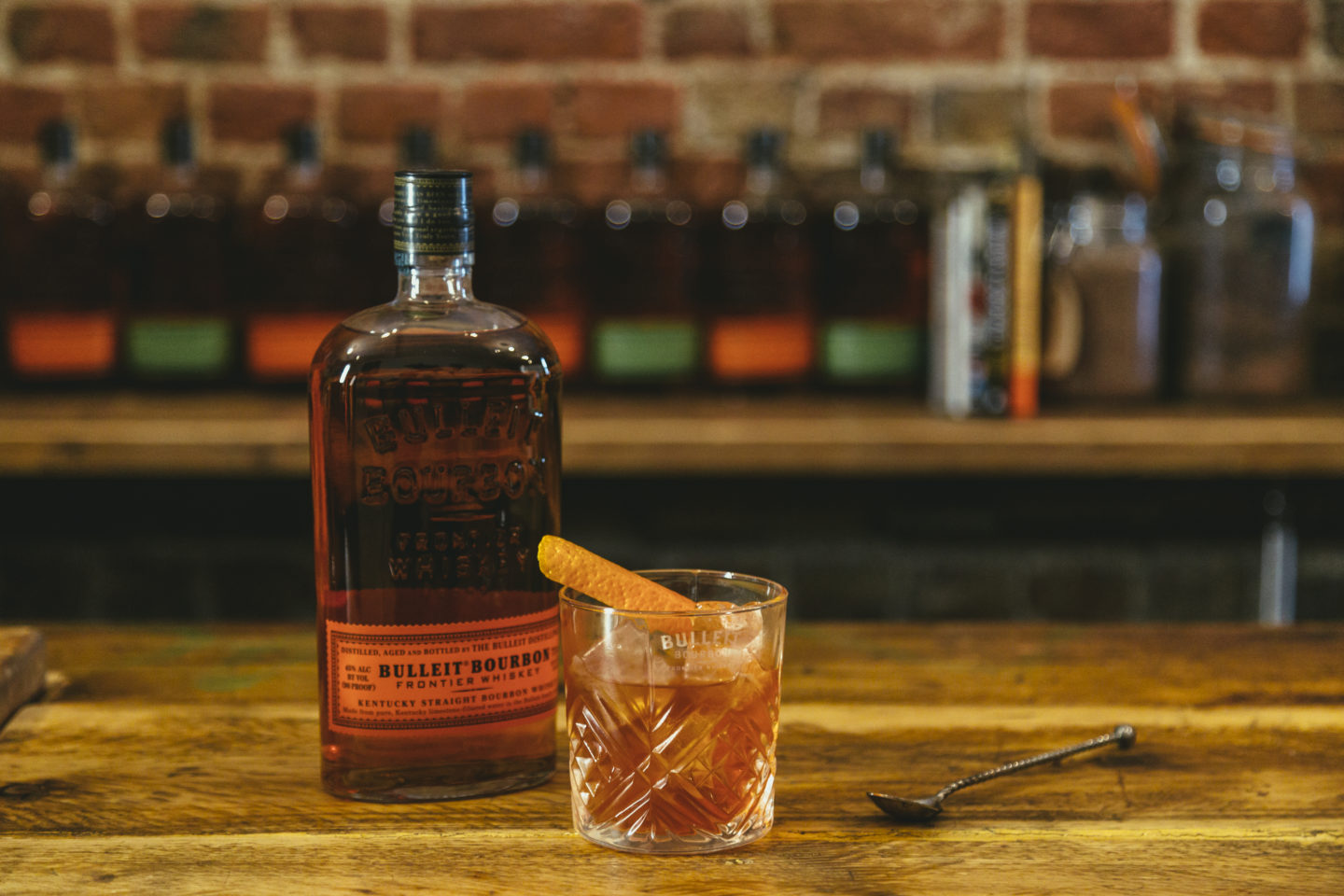 bourbon bottle and bourbon cocktail in a glass