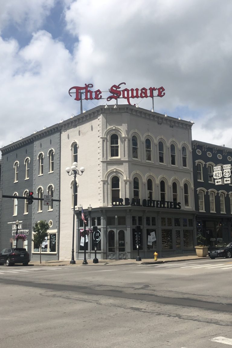 downtown of a city with a sign that says "the square"