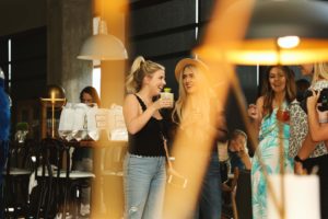 two girls drinking and talking