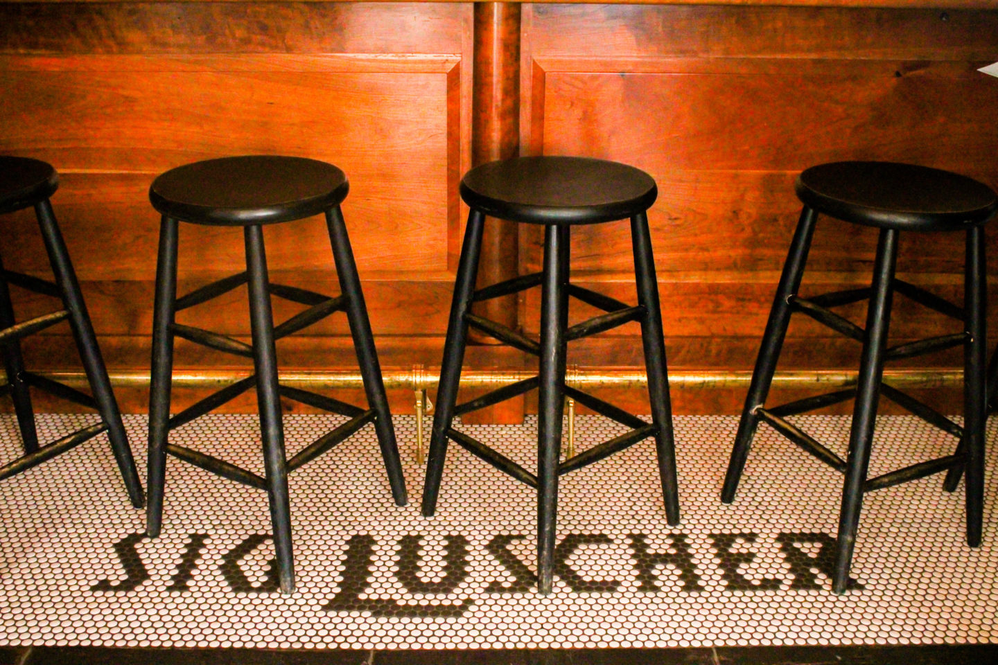 sig luscher tiled floor with bar stools