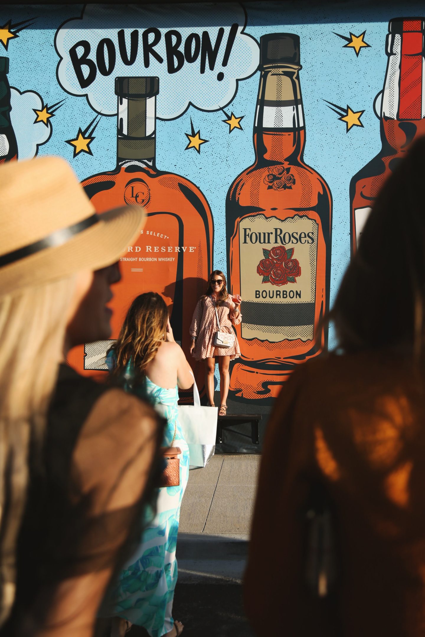 group of girls in front of a mural