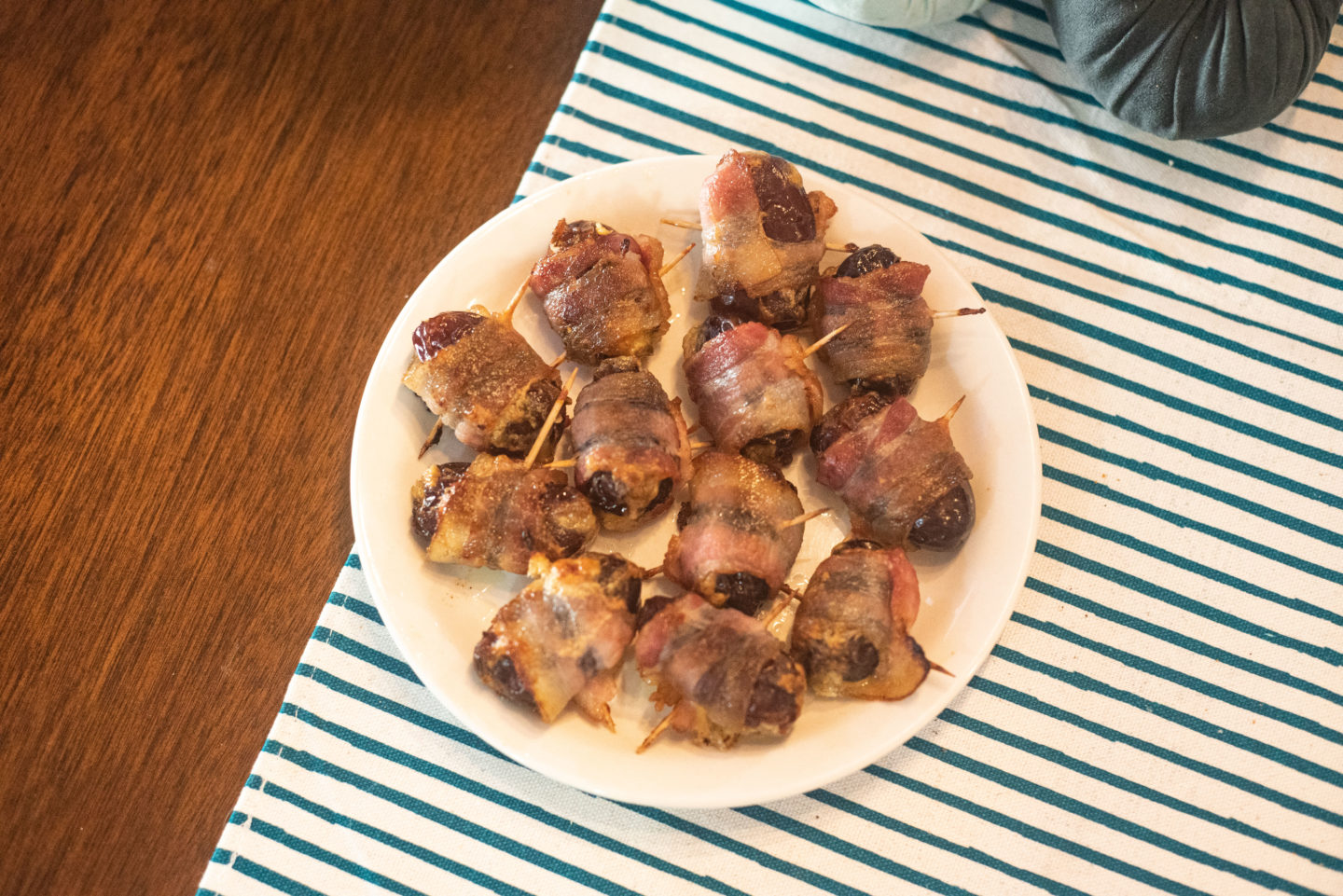 bacon wrapped pimento cheese stuffed dates on a plate