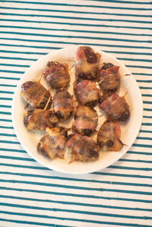 bacon wrapped pimento cheese stuffed dates on a plate