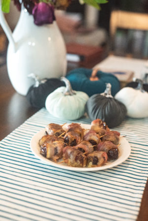 bacon wrapped pimento cheese stuffed dates on a plate