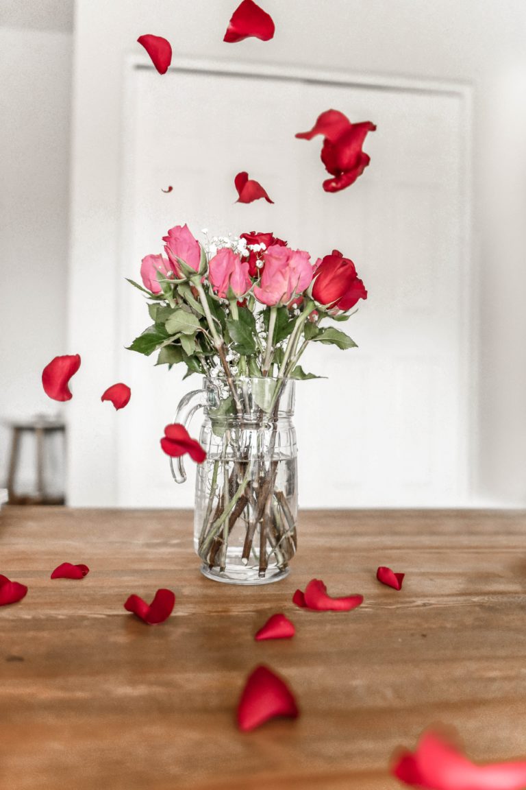 roses in a vase and rose petals