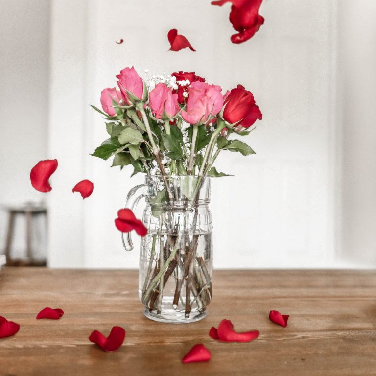 roses in a vase and rose petals