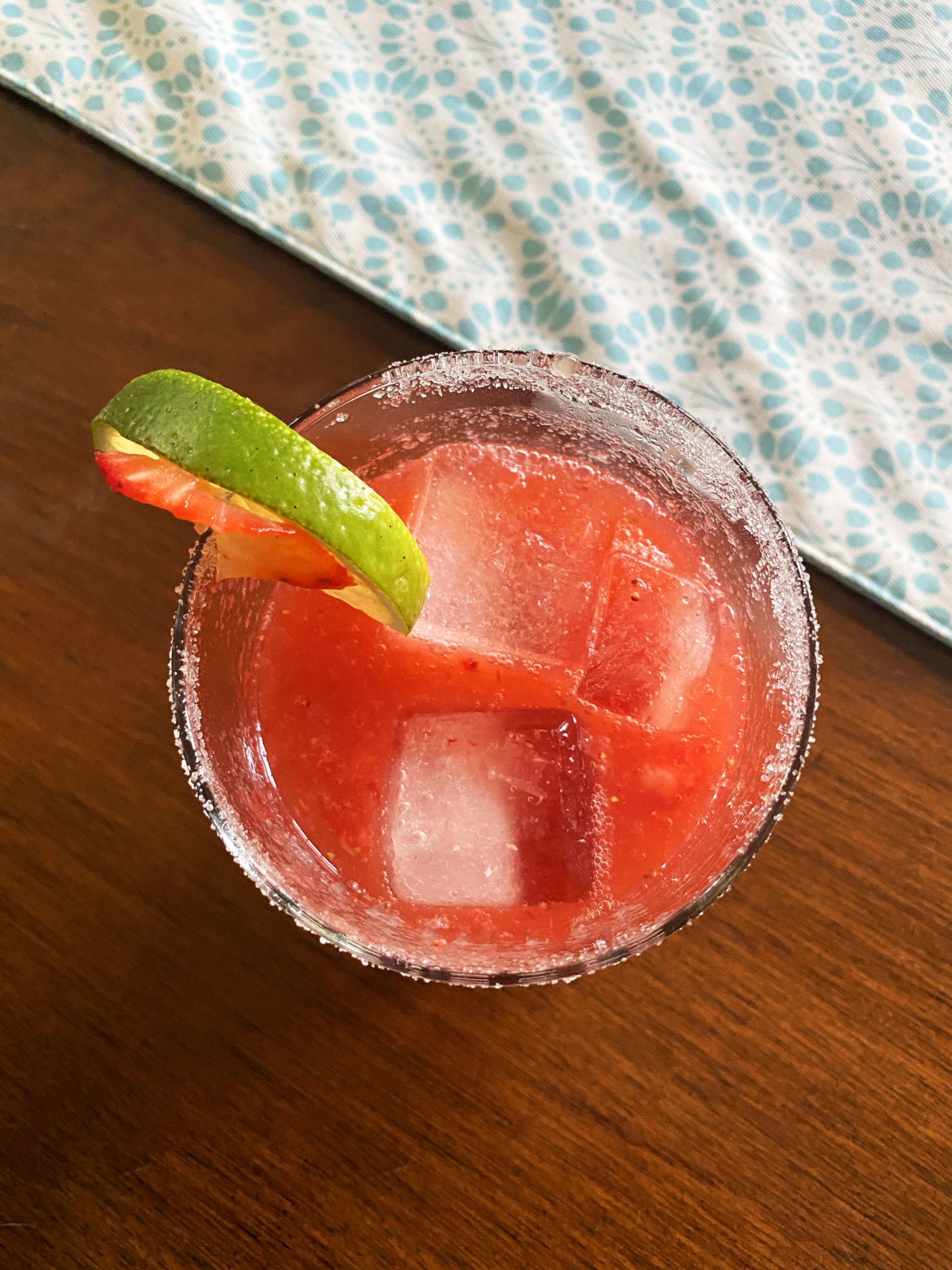 strawberry margarita with lime slice in glass