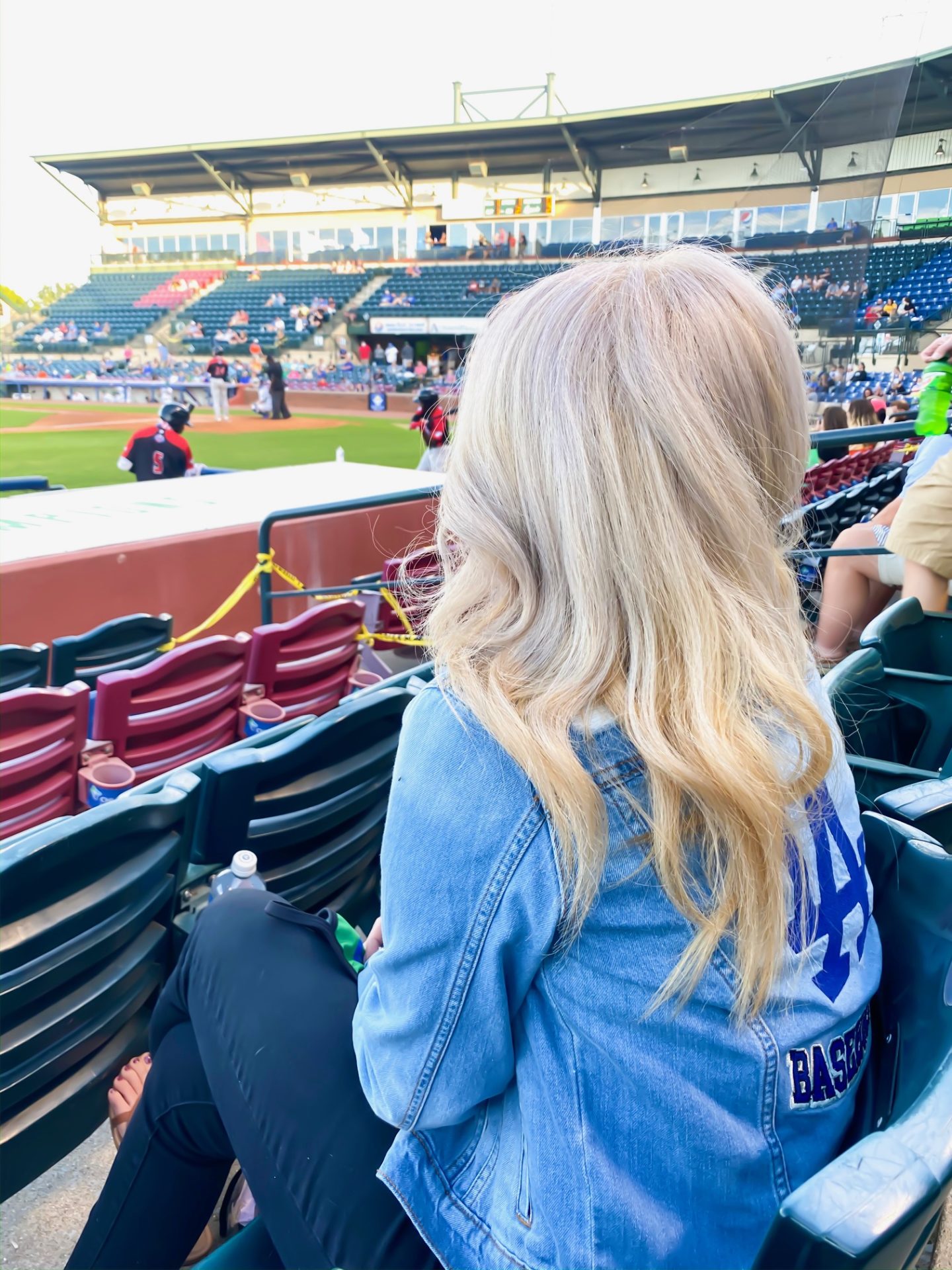 blonde girl watching baseball